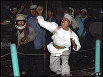 Ba'asyir's supporter throws a rock during a riot outside the prison where the cleric was held